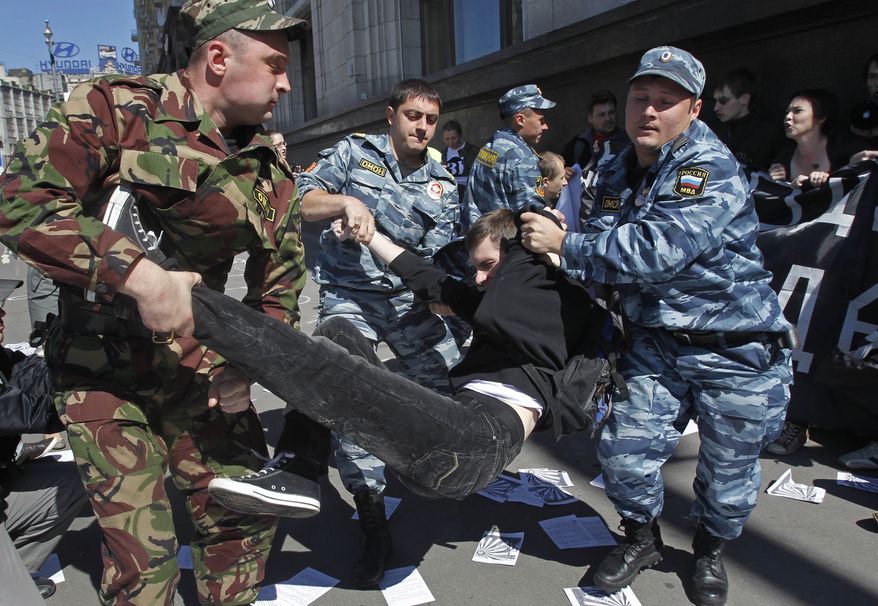 Russian police detain protesters outside the parliament building in Moscow on Tuesday, June 5, 2012, during a demonstration against a proposed law that would increase fines for participating in unsanctioned rallies. (AP Photo/Misha Japaridze)