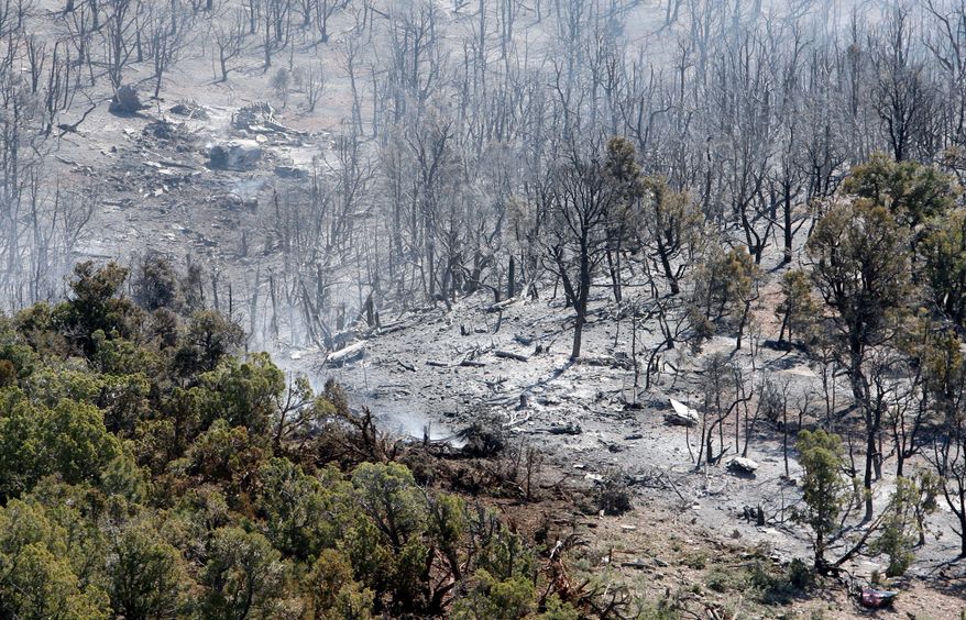 The crash scene of a heavy air tanker is seen from the air on June 4, 2012, near Hamblin Valley, Utah. The P2v Heavy air tanker crashed the previous day as it dropped retardant on a 5,000-acre wildfire, killing pilots Todd Neal Tompkins and Ronnie Edwin Chambless, both of Boise, Idaho. (Associated Press/The Deseret News)