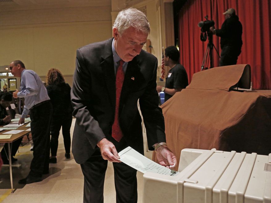 Wisconsin Democratic gubernatorial candidate Tom Barrett puts his ballot into a machine after voting June 5, 2012, in Milwaukee. Barrett is facing Republican Wisconsin Gov. Scott Walker in a recall election. (Associated Press)