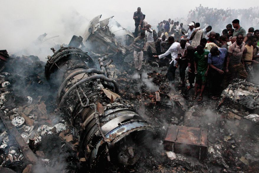 People converge on the remains of a commercial airliner on Sunday, the day it crashed in Lagos, Nigeria. All 153 onboard the aircraft and a still-unknown number of people on the ground were killed. Stuffed animals, flowers, candles and cards from neighbors and friends form a memorial (below) in front of the West Hartford, Conn. home of Onyeke and Maimuna Anyene and their four children, who were all killed in the crash. Family members who lost loved ones register their names on Tuesday before viewing the bodies that were moved to a Lagos teaching hospital (bottom) for identification(Associated Press)