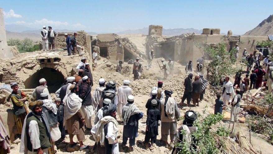 Villagers gather at a house destroyed in an apparent NATO raid in Logar province, south of Kabul, Afghanistan. Afghan officials and residents say a pre-dawn NATO airstrike aimed at militants in eastern Afghanistan killed civilians celebrating a wedding, including women and children. (Associated Press)