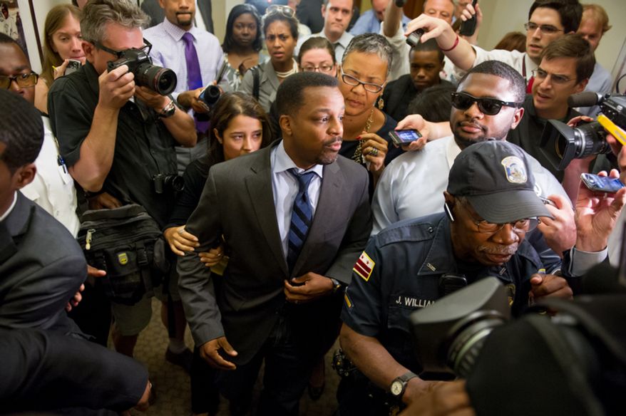 D.C. Council Chairman Kwame Brown leaves his office at the Wilson Building after being charged with one felony count of bank fraud and later resigned from the council, Washington, D.C., Wednesday, June 6, 2012. (Andrew Harnik/The Washington Times)