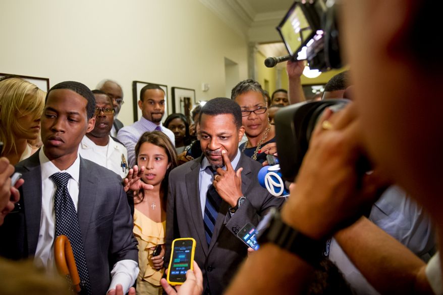 D.C. Council Chairman Kwame Brown leaves his office at the Wilson Building after being charged with one felony count of bank fraud. (Andrew Harnik/The Washington Times)