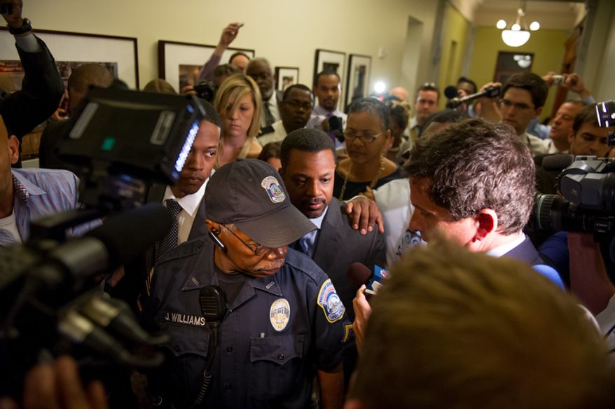 D.C. Council Chairman Kwame Brown leaves his office at the Wilson Building after being charged with one felony count of bank fraud and later resigned. (Andrew Harnik/The Washington Times)
