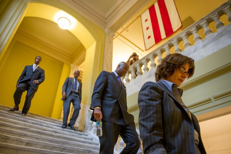 D.C Counci member and chairman pro tempore Mary Cheh (D-Ward 3), right, council members Michael A. Brown (D-At Large), second from right, and newly elected Kenyan McDuffie (D-Ward 5), left, leave a private meeting at the Wilson Building as Council Chairman Kwame R. Brown (D) is charged with one felony count of bank fraud and is expected to resign his from the council, Washington, D.C., Wednesday, June 6, 2012. (Andrew Harnik/The Washington Times)