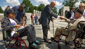 Rep. John D. Dingell (center), Michigan Democrat, speaks with retired Navy Seaman McKenley Morgan (left) of Flint, Mich.; his son Bruce Morgan (second from left) of Virginia Beach; and retired Army Sgt. Stanley Kaczor (right) of Woodhaven, Mich., at the World War II Memorial in Washington on Wednesday, June 6, 2012, the 68th anniversary of D-Day, as part of the Honor Flights program, which flies U.S. veterans to Washington to visit the memorials on the National Mall. Both the elder Mr. Morgan and Mr. Kaczor are World War II veterans, as is Mr. Dingell. (Andrew Harnik/The Washington Times)