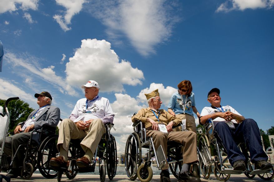 Honor Flight guardian Lisa Williams, of Lexington, Ky., second from right, chats with World War II veterans retired Pfc. Harold Slaughter, 85, of Sellersburg Ind., left, retired Army Cpl. Wilmer Peck, 86, of Franklyn, Ky., second from left, retired Army Cpl. Edgar Casada, 88, of Highland, Ind., third from right, and retired Army Pfc. Walter Points, 93, of Falmouth, Ky., right, while visiting the World War II memorial on the 68th anniversary of D-Day. (Andrew Harnik/The Washington Times)