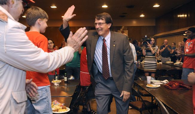 Democratic state Senate candidate John Lehman gives a high-five to a young supporter as he arrives for an election-night party at the Racine Labor Center in Racine, Wis., on Tuesday, June 5, 2012. (AP Photo/Scott Anderson, Journal Times)
