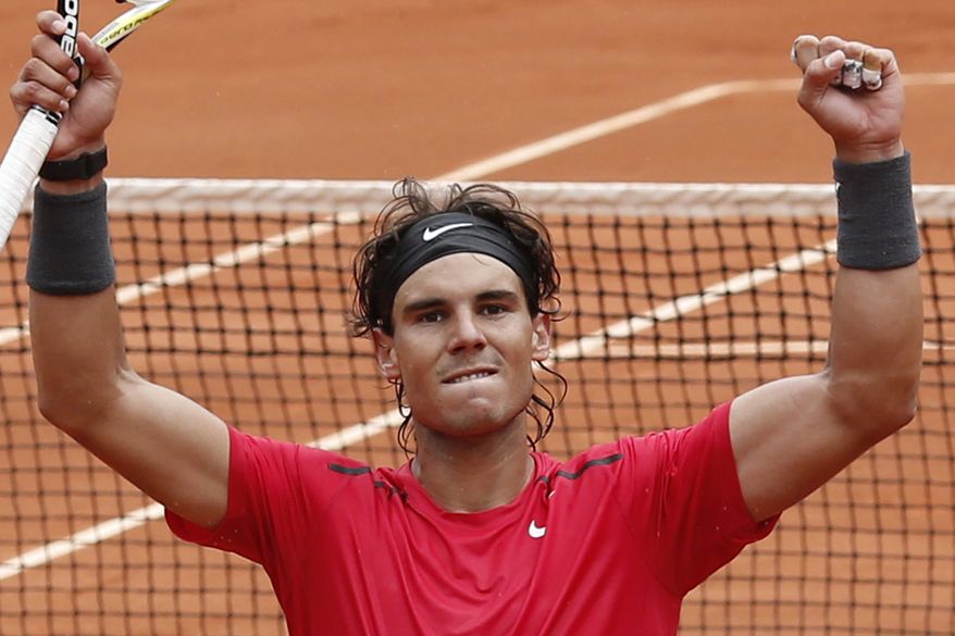 Rafael Nadal celebrates winning his quarter final match against Nicolas Almagro at the French Open atRoland Garros stadium in Paris on Wednesday June 6, 2012. Nadal won in three sets: 7-6, 6-2, 6-3. (AP Photo/Bernat Armangue)