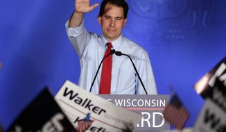 Wisconsin Gov. Scott Walker waves during his victory party on Tuesday, June 5, 2012, in Waukesha, Wis., after defeating Democratic challenger Tom Barrett in a special recall election. (AP Photo/Morry Gash)

