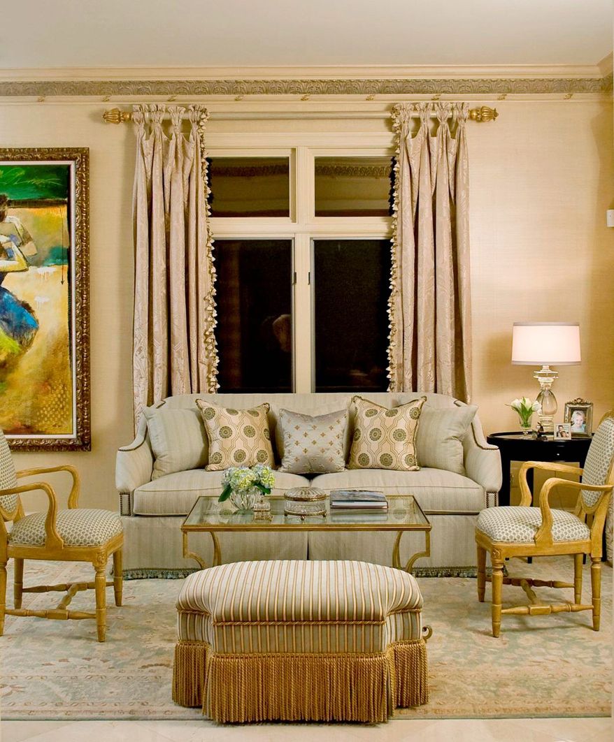 Photo by Gin Hunt
Designer Sharon Kleinman, owner of Transitions in Potomac, shows how adding decorative trim to various items in a room, such as window treatments, the sofa and ottoman, can create a more luxurious look.