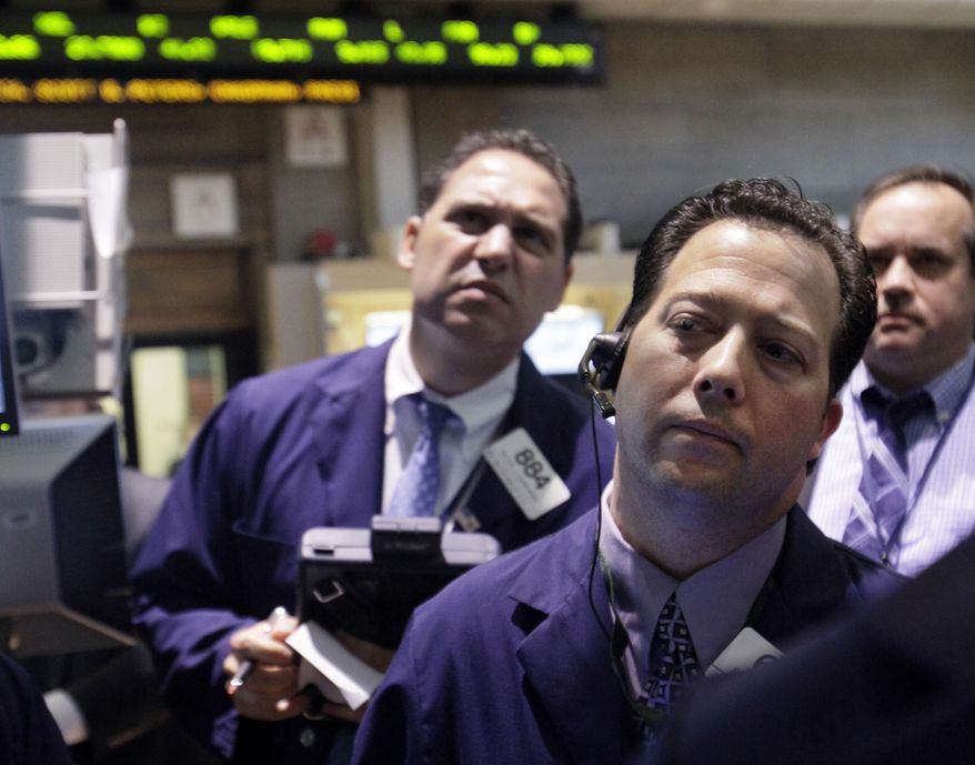 Traders work June 7, 2012, on the floor of the New York Stock Exchange. (Associated Press)