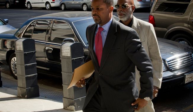 Former D.C. Council Chairman Kwame R. Brown (left) enters the E. Barrett Prettyman Federal Courthouse for his plea hearing in Washington, D.C., Friday, June 8, 2012. (Rod Lamkey Jr/The Washington Times)
