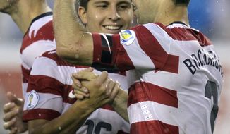 U.S.defender Carlos Bocanegra (3) celebrates with Jose Torres (16) after scoring a first-half goal against Antigua and Barbuda during a World Cup qualifying soccer game Friday, June 8, 2012, in Tampa, Fla. (AP Photo/Chris O&#39;Meara)
