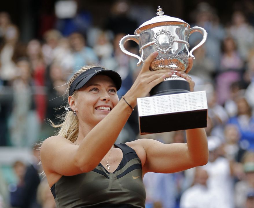 Maria Sharapova holds the trophy after winning the women's final match against Sara Errani at the French Open in Roland Garros stadium in Paris, Saturday June 9, 2012. Sharapova won in two sets 6-3, 6-2. (AP Photo/Michel Euler)