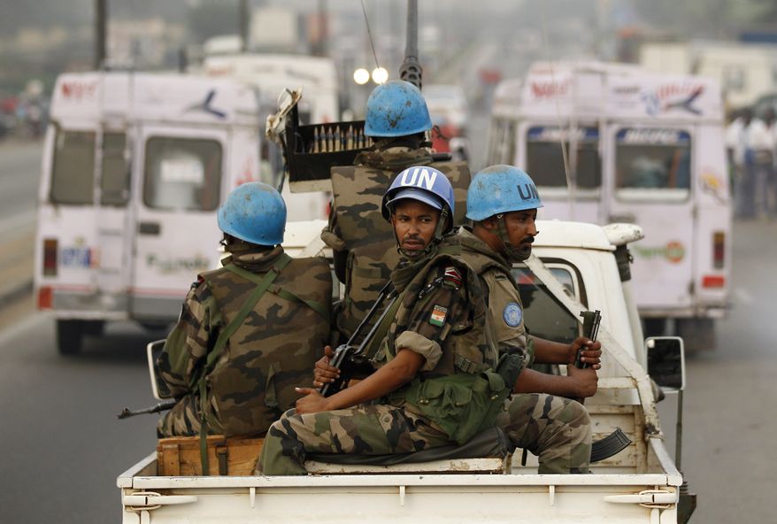** FILE ** U.N. soldiers from Niger conduct a patrol through the streets of Abidjan, Ivory Coast, on Jan. 10, 2011. (AP Photo/Rebecca Blackwell)