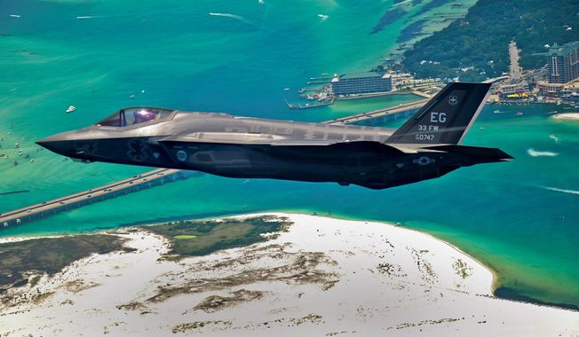 An F-35 Joint Strike Fighter soars over Destin, Fla., before landing at its new home at Eglin Air Force Base. Purchasing more of the fighters would be off the table in 2014 if automatic federal spending cuts go into effect. (Associated Press)