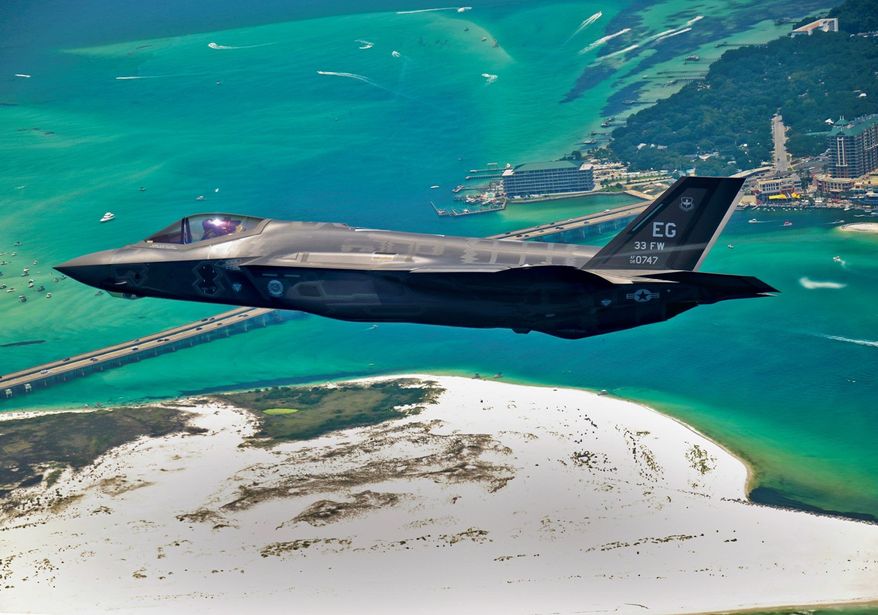 An F-35 Joint Strike Fighter soars over Destin, Fla., before landing at its new home at Eglin Air Force Base. Purchasing more of the fighters would be off the table in 2014 if automatic federal spending cuts go into effect. (Associated Press)