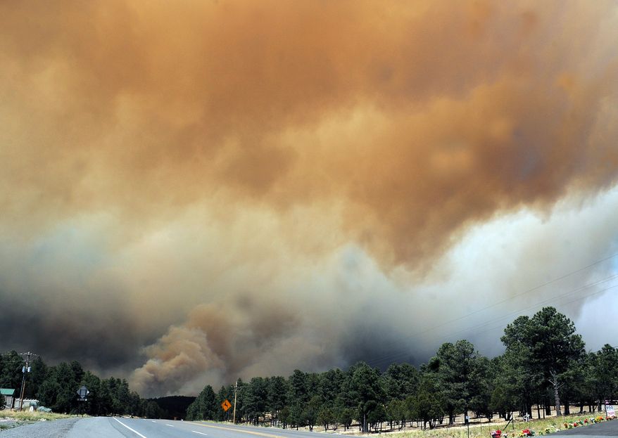 Smoke billows from the Little Bear fire in southeastern New Mexico, near Ruidoso, on Saturday, June 9, 2012. (AP Photo/Roswell Daily Record, Mark Wilson)