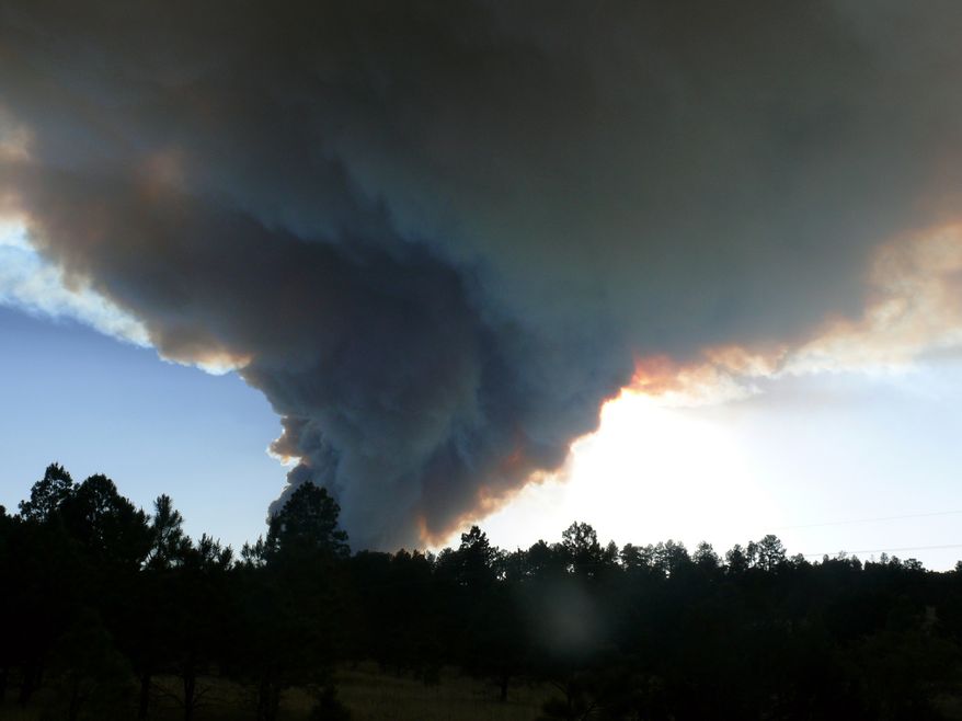 Smoke billows from the Little Bear fire in southeastern New Mexico, near Ruidoso, on Saturday, June 9, 2012. (AP Photo/Ruidoso News, Jim Kalvelag)