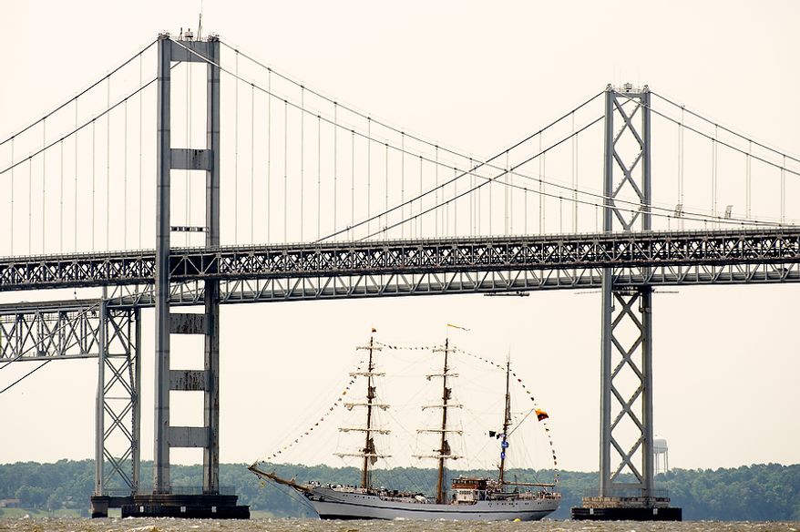 A tall ship passes under the Chesapeake Bay Bridge at Sandy Point State Park in Annapolis, Md., en route to the Inner Harbor in Baltimore for a bicentennial commemoration of the War of 1812. The week-long "Star-Spangled Sailabration" includes free tours of the ships, waterside festivities, an air show featuring the Blue Angels and the world premiere of "Overture for 2012," composed by Philip Glass. (Andrew Harnik/The Washington Times)