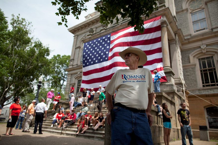 Elmo Sherman of Reynoldsburg, Ohio, waits for a stop Sunday in Newark, Ohio, by the Romney campaign in front of the county courthouse. (Associated Press)