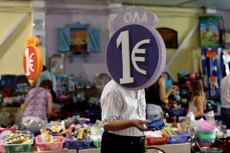 Customers browse discounted goods for sale at a "1 euro store" Monday in Athens. Greeks voted Sunday for parties supporting the nation's bailout package, which Mr. Obama, at the G-20 summit, said "indicates a positive prospect." (Associated Press)