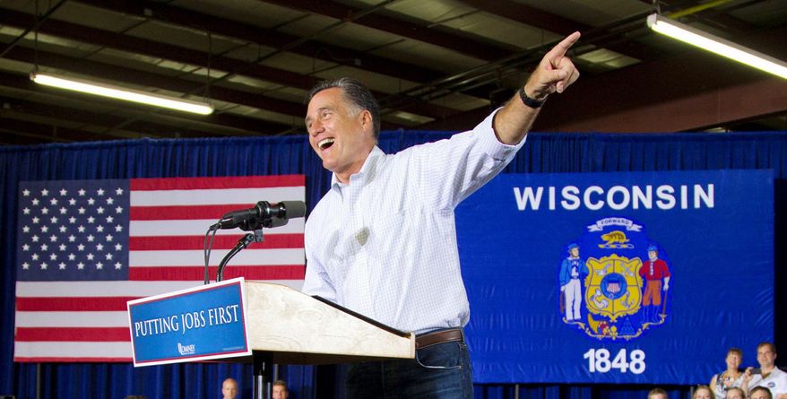 On a bus tour of Wisconsin that included a stop Monday at Montery Mills in Janesville, Mitt Romney had a carefully modulated response to President Obama's surprise decision on illegal immigrants. (Associated Press)