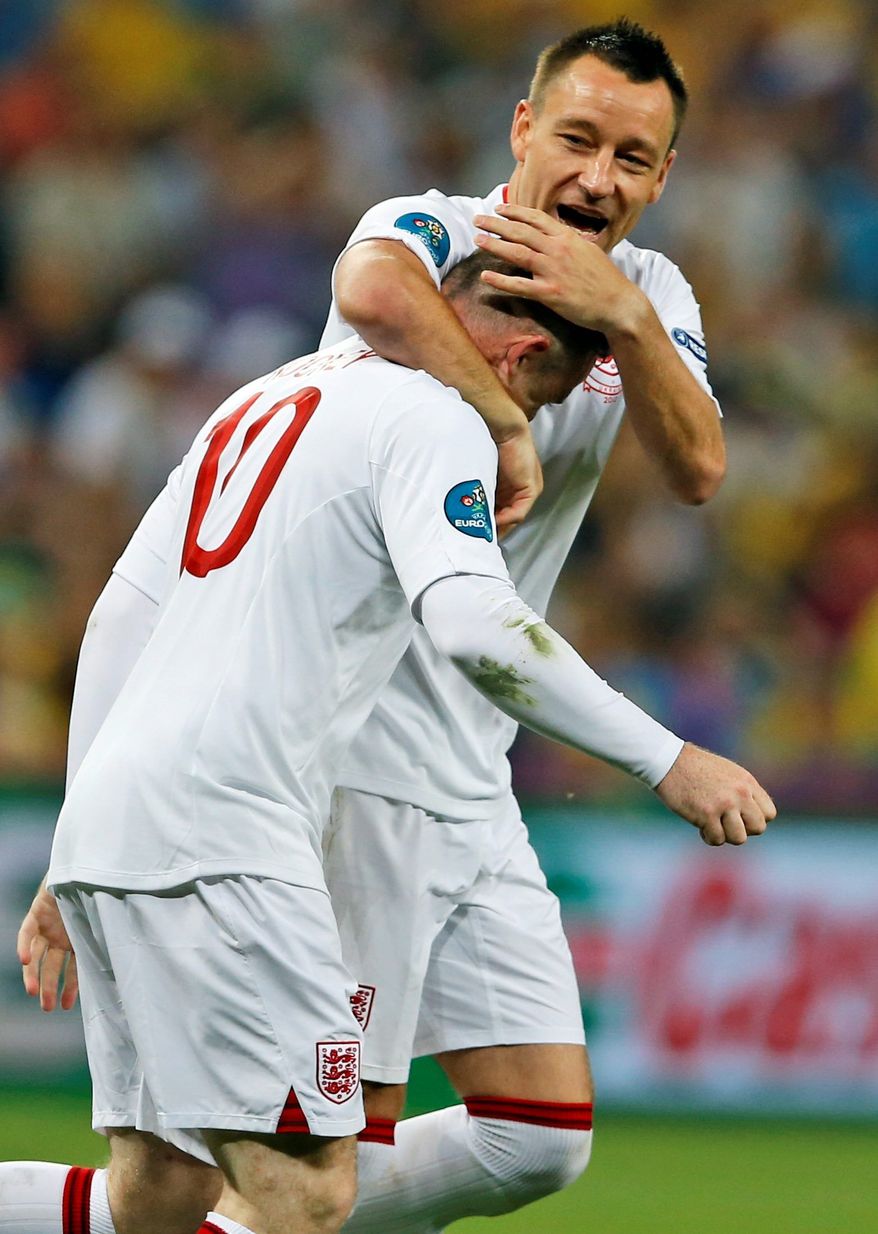 associated press
Wayne Rooney (left)and John Terry celebrate after Rooney scored England&#39;s only goal in a win over Ukraine.