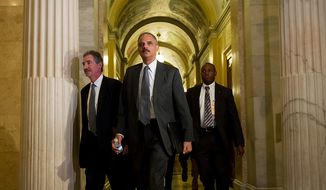 Attorney General Eric H. Holder Jr. arrives with Deputy Attorney General James Cole (left) at the U.S. Capitol in Washington on Tuesday, June 19, 2012, to meet with the House leadership to discuss the congressional investigation into the botched anti-gunrunning Fast and Furious operation. (Andrew Harnik/The Washington Times)