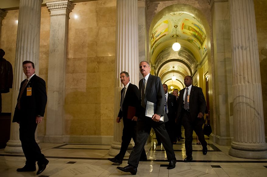 Attorney General Eric H. Holder Jr. arrives with Deputy Attorney General James Cole (second from left) at the U.S. Capitol in Washington on Tuesday, June 19, 2012, to meet with the House leadership to discuss the congressional investigation into the botched anti-gunrunning Fast and Furious operation. (Andrew Harnik/The Washington Times)