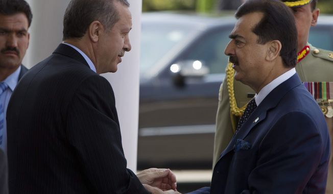 **FILE** Turkish Prime Minister Recep Tayyip Erdogan (left) shakes hands May 22, 2012, with Pakistani Prime Minister Yousuf Raza Gilani at his house in Islamabad, Pakistan. (Associated Press)