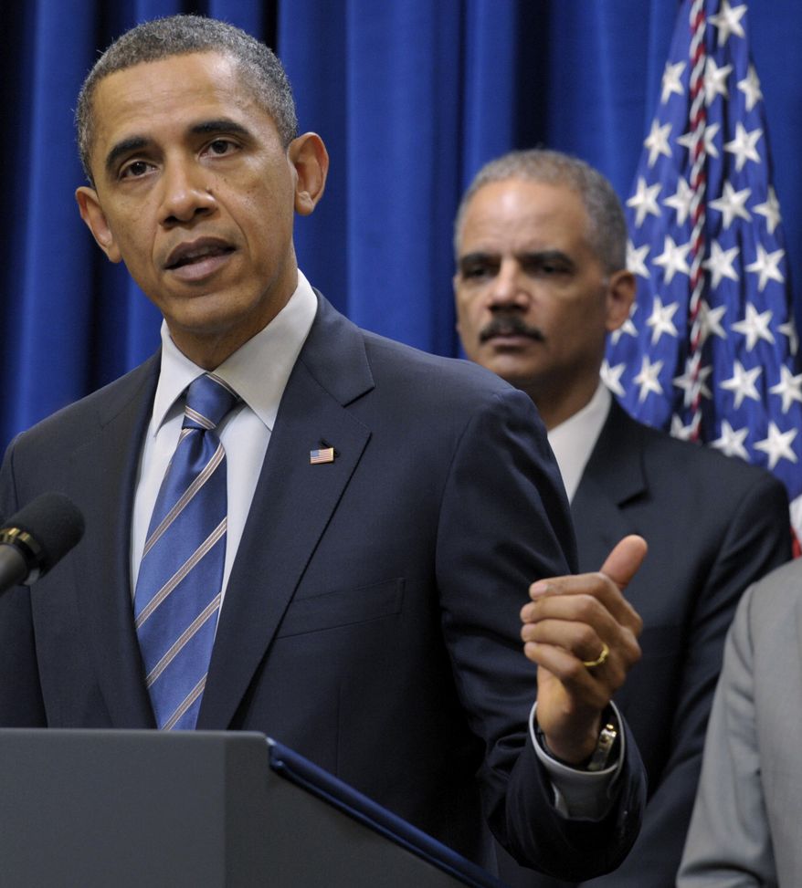 **FILE** President Obama (left) speaks Feb. 9, 2012, in Washington about a settlement with the nation's five largest banks over foreclosures. Attorney General Eric H. Holder Jr. is in the background. (Associated Press)