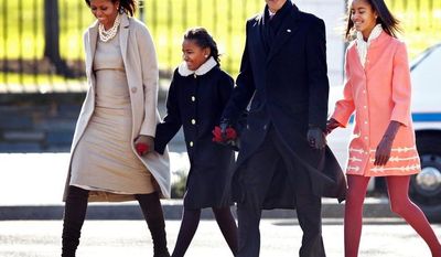 ** FILE ** In this December 2011 file photo, President Obama with first lady Michelle Obama and their daughters, Sasha and Malia, walk from the White House to attend a Sunday service at St. John's Church, where every president since James Madison has worshipped. (Associated Press)