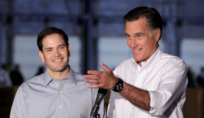 Republican presidential candidate Mitt Romney (right), campaigning with Sen. Marco Rubio of Florida, talks to reporters in Aston, Pa., in April 2012. (Associated Press) ** FILE **