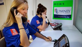 Shannon Westfield, 20, (left) and Jane Kernan, 16, make calls for Mitt Romney in Fairfax wearing T-shirts with a QR code that voters can zap with their smartphones to learn more about the GOP presidential hopeful. In May, Mr. Romney&#39;s fundraising almost matched President Obama&#39;s, taking in $58 million. (Associated Press)