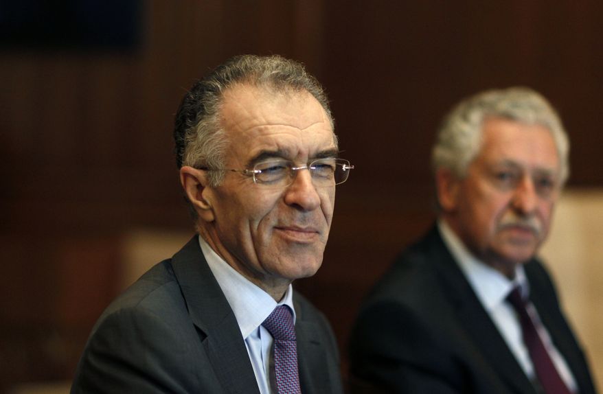 Prominent banker Vassilis Rapanos (left) and Fotis Kouvelis, leader of the Democratic Left party, attend a meeting of the Greek government coalition in Athens on Thursday, June 21, 2012. (AP Photo/Kostas Tsironis)