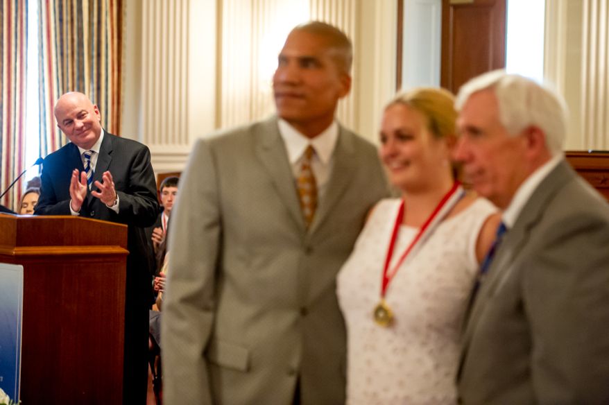 Thomas P. McDevitt, President of the Washington Times Newspaper, left, acts as the Master of Ceremonies as youth are awarded the Congressional Award Gold Medal during an award ceremony in the Cannon House Office Building on Capitol Hill, Washington, D.C., Wednesday, June 20, 2012. The 276 youth honored this year in the annual award ceremony for completing 400 hours of Voluntary Public Service activities, 200 hours each of Personal Development and Physical Fitness activities, as well as an Expedition and Exploration activity were greeted by members of congress as well as Verdine White and Ralph Johnson, two members of Earth, Wind, and Fire. (Andrew Harnik/The Washington Times)