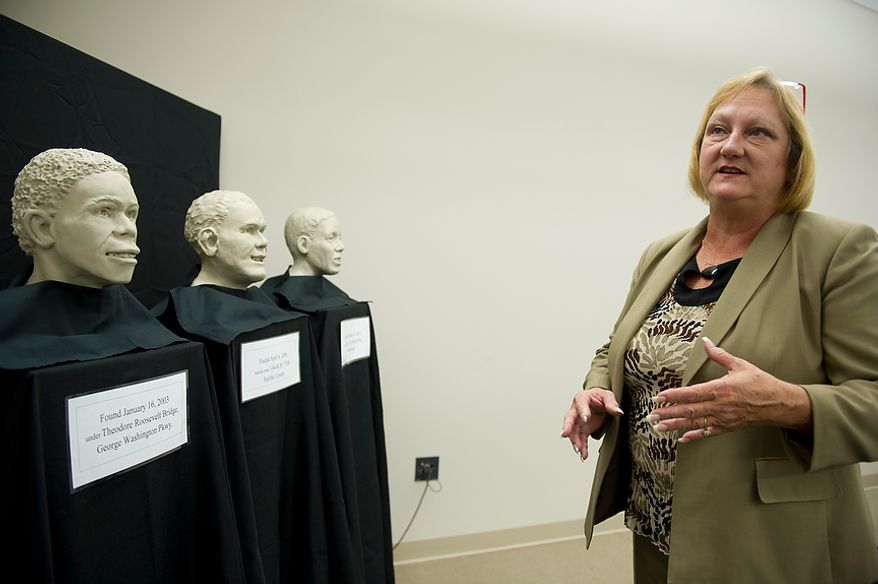 Leah Bush, chief medical examiner for the Commonwealth of Virginia, seen here with the facial approximations of three unidentified men whose remains were found in Northern Virginia between 2003 and 2011, explains that the reconstructions are made with neutral coloring so as not to sway any potential identifiers that this might — or might not — be their loved one. The three approximations were unveiled Thursday, June 21, 2012 in Manassas, Va., and will remain on display at the office of the chief medical examiner. (Barbara L. Salisbury/The Washington Times)