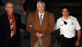 Jerry Sandusky leaves the Centre County Courthouse in Bellefonte, Pa., on Friday, June 22, 2012, after being found guilty in his sexual abuse trial. (AP Photo/Centre Daily Times, Nabil K. Mark)
