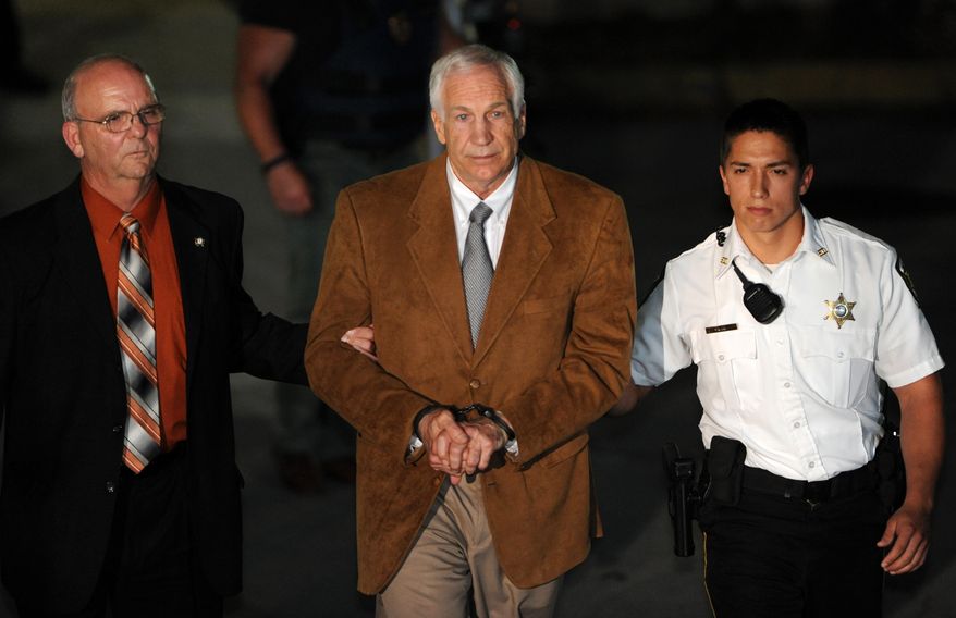 Jerry Sandusky leaves the Centre County Courthouse in Bellefonte, Pa., on Friday, June 22, 2012, after being found guilty in his sexual abuse trial. (AP Photo/Centre Daily Times, Nabil K. Mark)