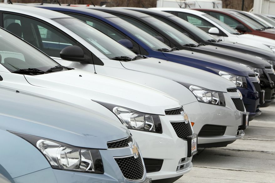 **FILE** A line of 2012 Chevrolet Cruze sedans sits Feb. 19, 2012, at a dealership in the south Denver suburb of Englewood, Colo. (Associated Press)