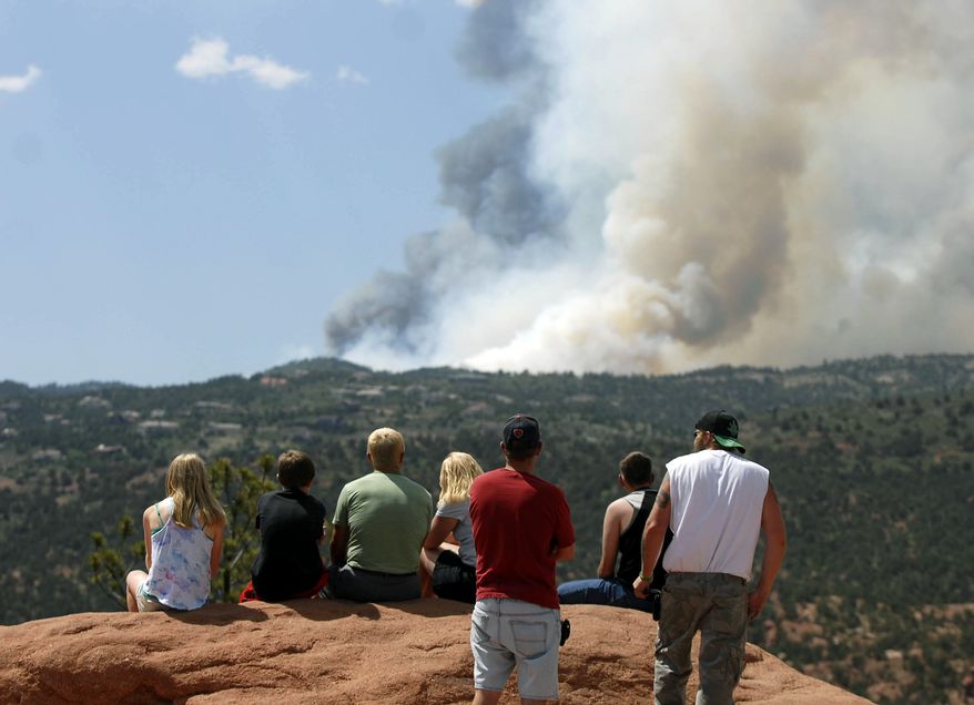 Smoke billows from a wildfire west of Colorado Springs, Colo., on Saturday, June 23, 2012. (AP Photo/Bryan Oller)