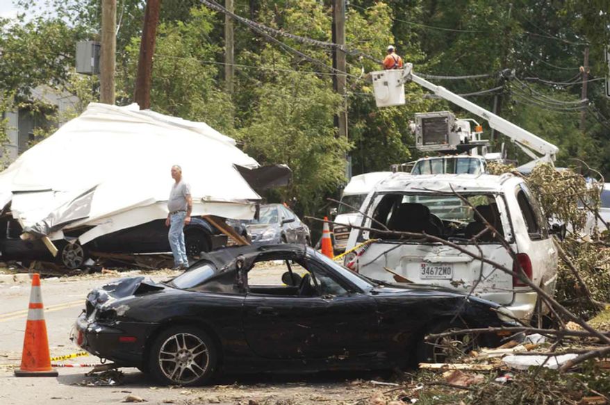 Utility crews work to fix damage equipment near Newton St. and 54th Avenue on Sunday, June 24, 2012, in Bladensburg, Md. A mircoburst, a small concentrate downdraft, struck the area on Friday evening. (Raymond Thompson/The WashingtonTimes)