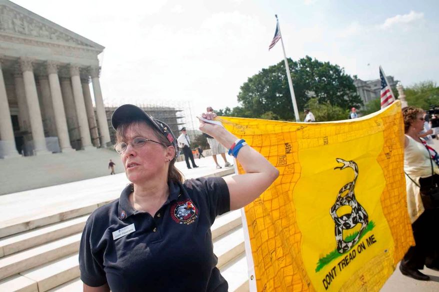 ** FILE ** Judy Pepenella, a New York resident and member of the Conservative Society for Action, protests the health care reform law Monday outside the U.S. Supreme Court. She said she is part of a group of 50 doctors who filed a friend-of-the-court brief advocating that so-called Obamacare be struck down. (Raymond Thompson Jr./The Washington Times)