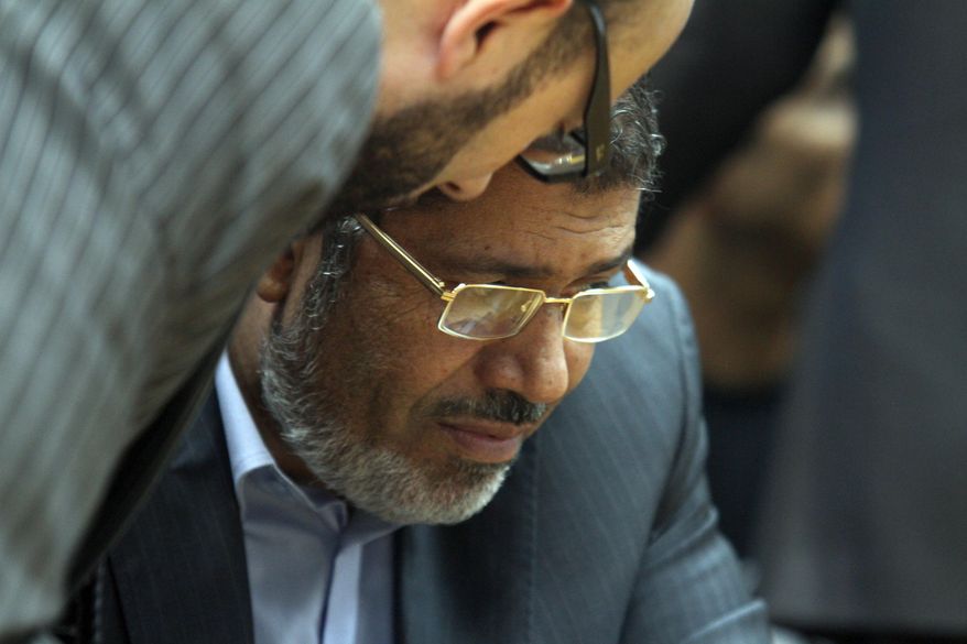 ** FILE ** Then-Egyptian presidential candidate Mohammed Morsi confers with an aide on Sunday, June 3, 2012. (AP Photo/Ahmed Gomaa)