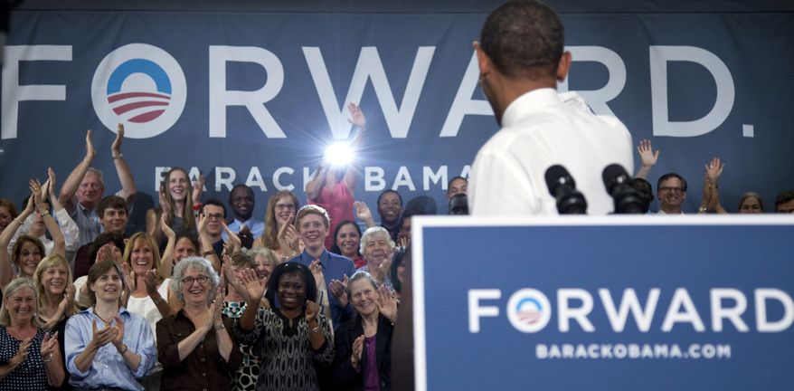 President Obama turns to wave to the people on the stage as he speaks June 25, 2012, at Oyster River High School in Durham, N.H. (Associated Press)