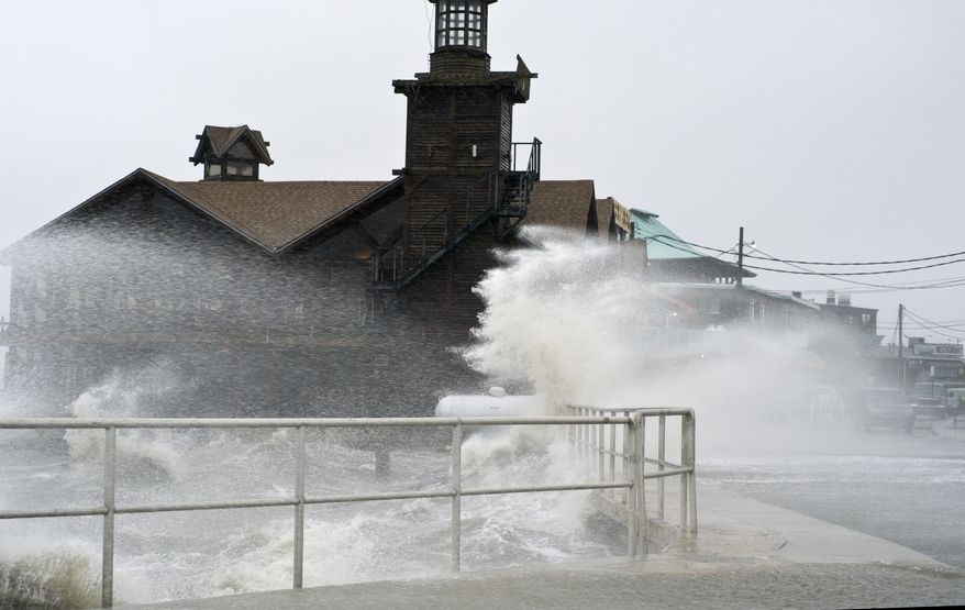 High winds and a high tide combine to strike at the main street of Cedar Key, Fla., as Tropical Storm Debby makes its way across the Gulf of Mexico on Sunday, June 24, 2012. (AP Photo/Phil Sandlin)