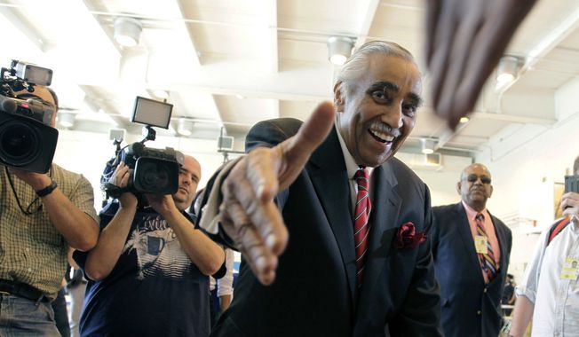 ** FILE ** Rep. Charles Rangel, New York Democrat, shakes hands with a poll worker June 26, 2012, as he arrives to vote in the Democratic primary in New York. (Associated Press)
