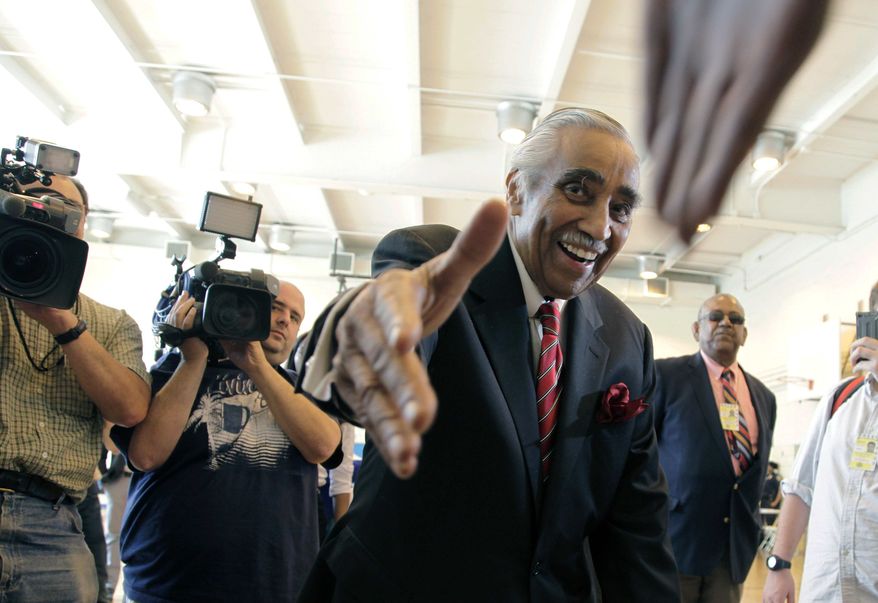 ** FILE ** Rep. Charles Rangel, New York Democrat, shakes hands with a poll worker June 26, 2012, as he arrives to vote in the Democratic primary in New York. (Associated Press)
